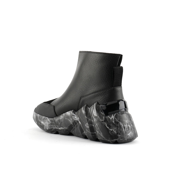 space kick v boot women black marble angle in view